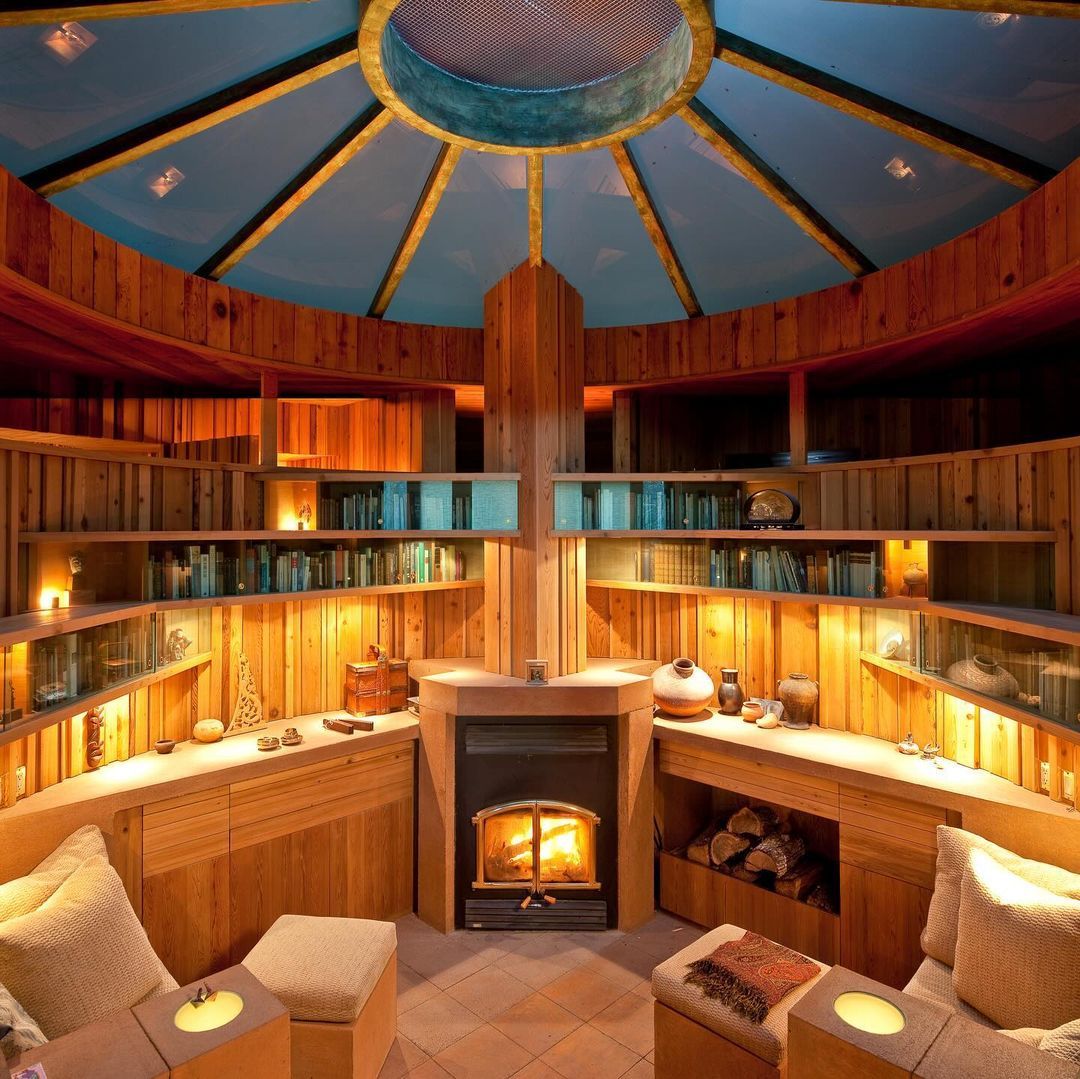 Interior hallway with a large elliptical wood-framed portal and soft pink trim.