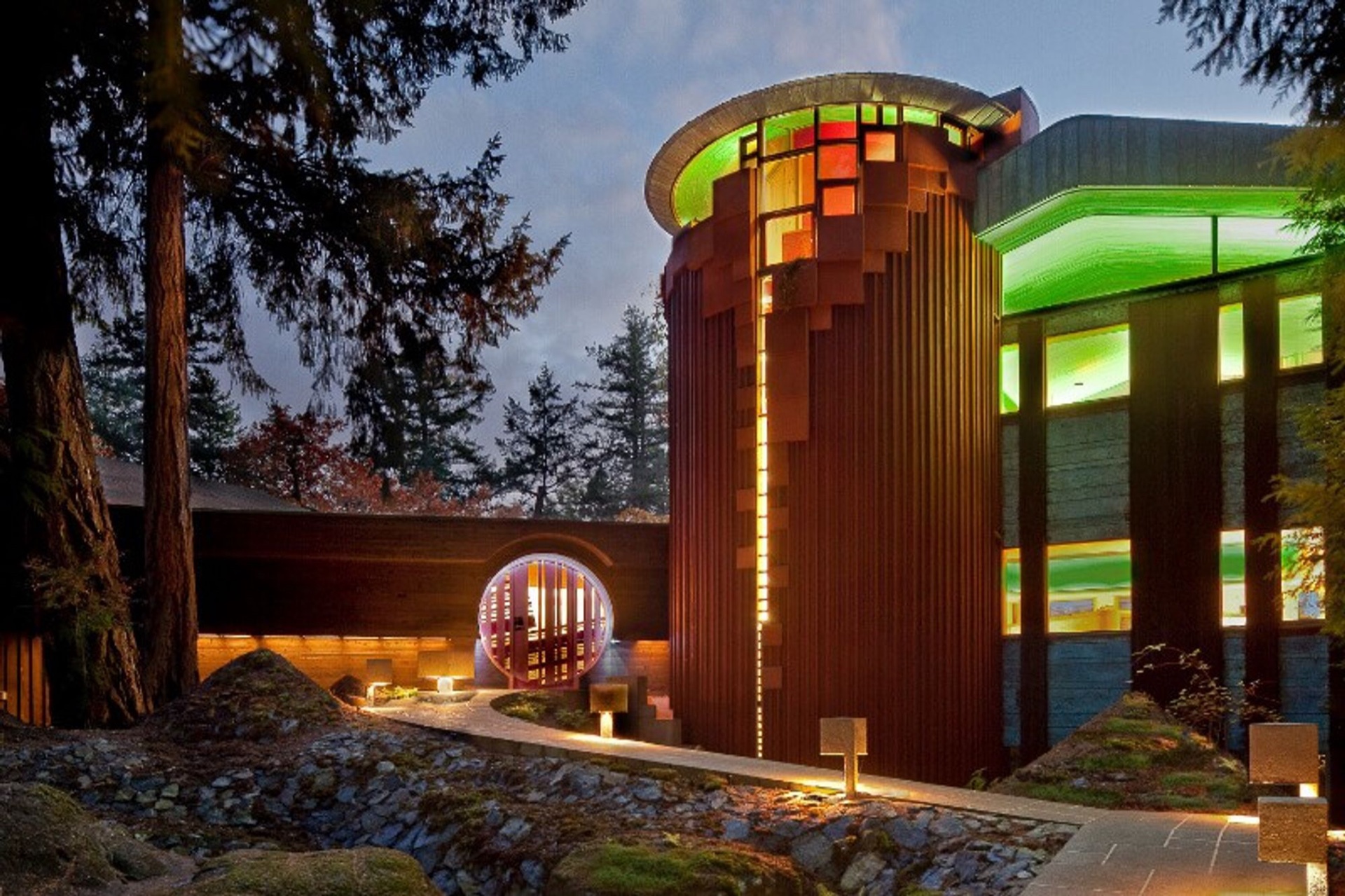 203 Goward Road at dusk — the cylindrical tower of the Hunter Residence glowing among the trees.